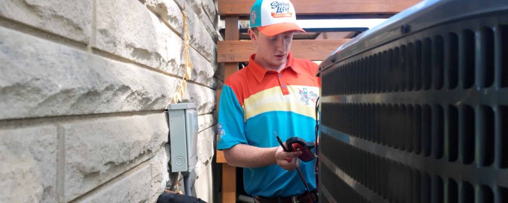 Sweet Life Heating, Cooling and Electric technician providing AC installation services.