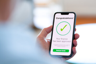 Man looking at a loan finance application approval