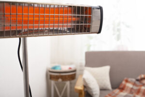 Electric infrared heater warming up living room with sofa